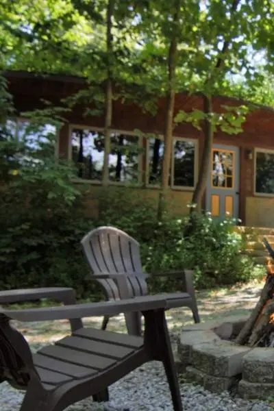 a house with chairs and fire-pit outside