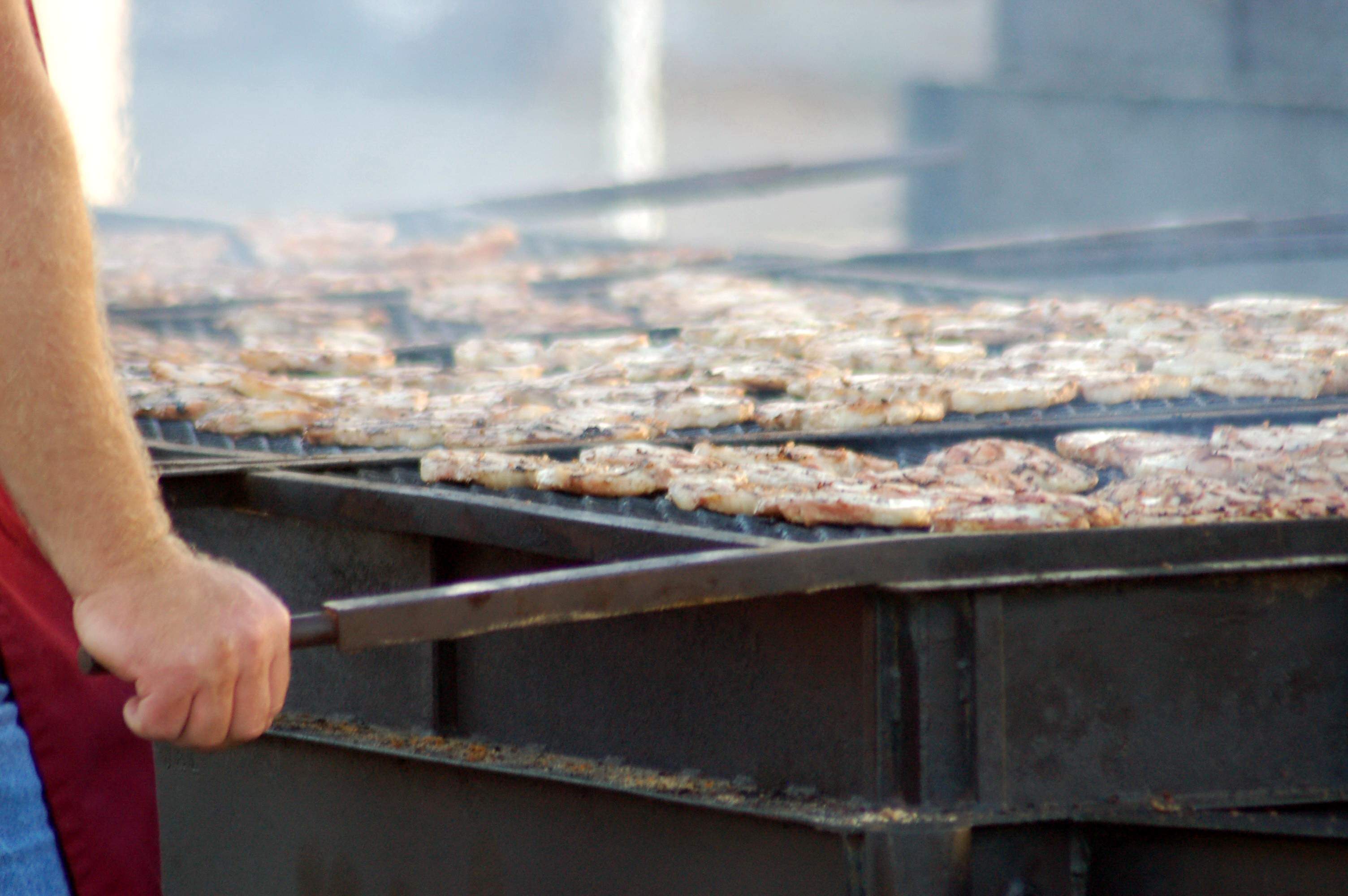 A barbecue cook grilling pork chops at the Kewanee Hog Days