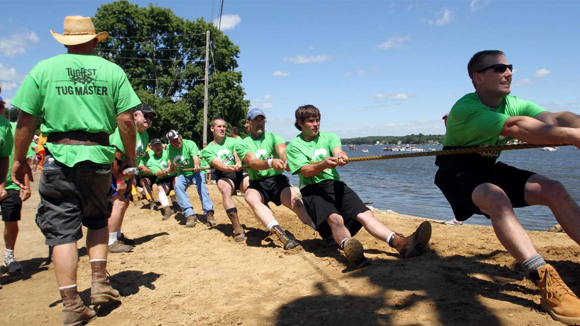 A line of people taking part in a tug of war competition at Tug Fest in Port Byron