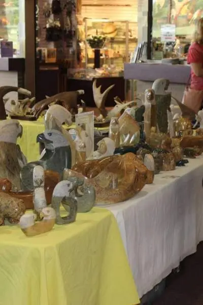 A woman browses art at a holiday market