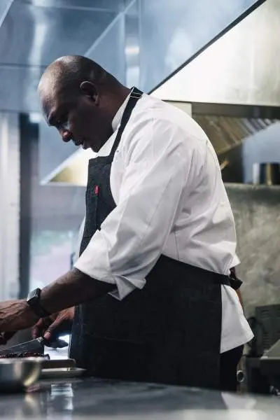 Chef Erick Williams prepping ingredients at Virtue Restaurant.