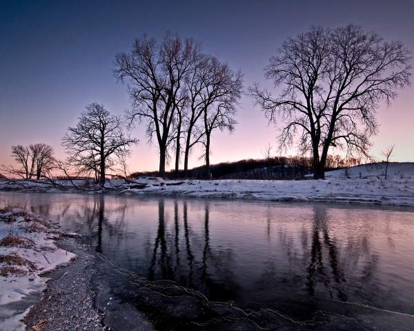 The snow-lined banks of Nippersink Creek at dusk, in Glacial Park, McHenry County