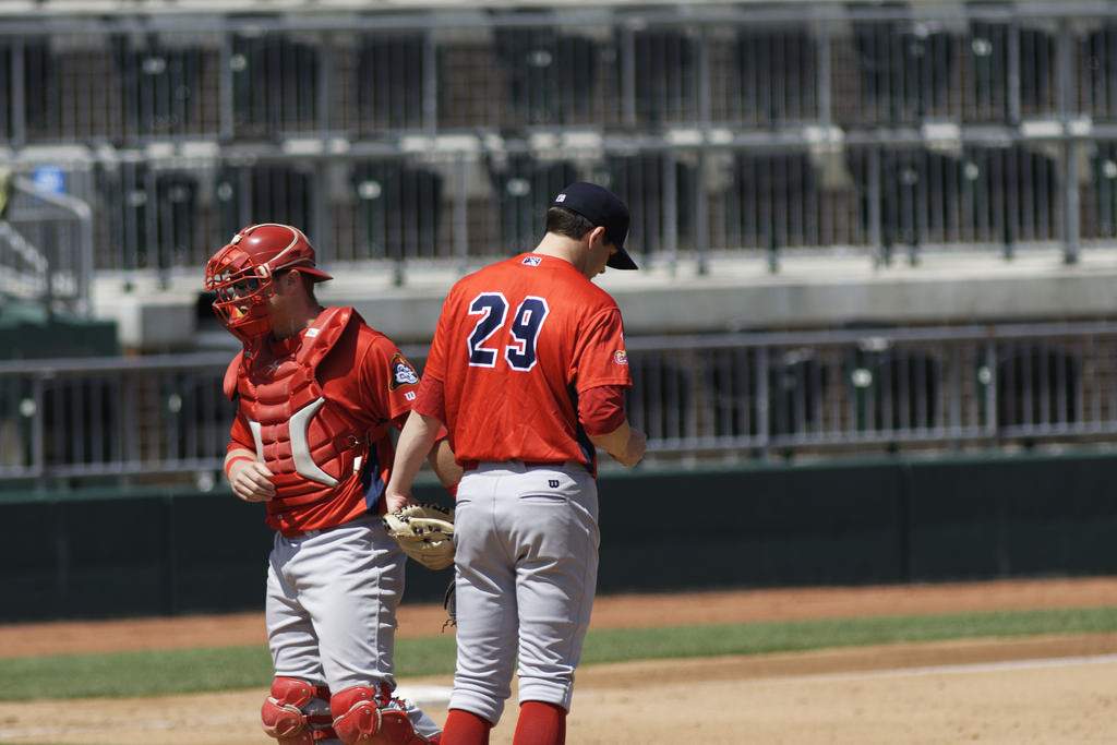 Peoria Chiefs players congregate on the mound